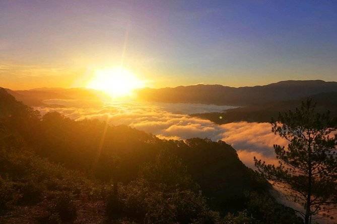 sun setting above mountains