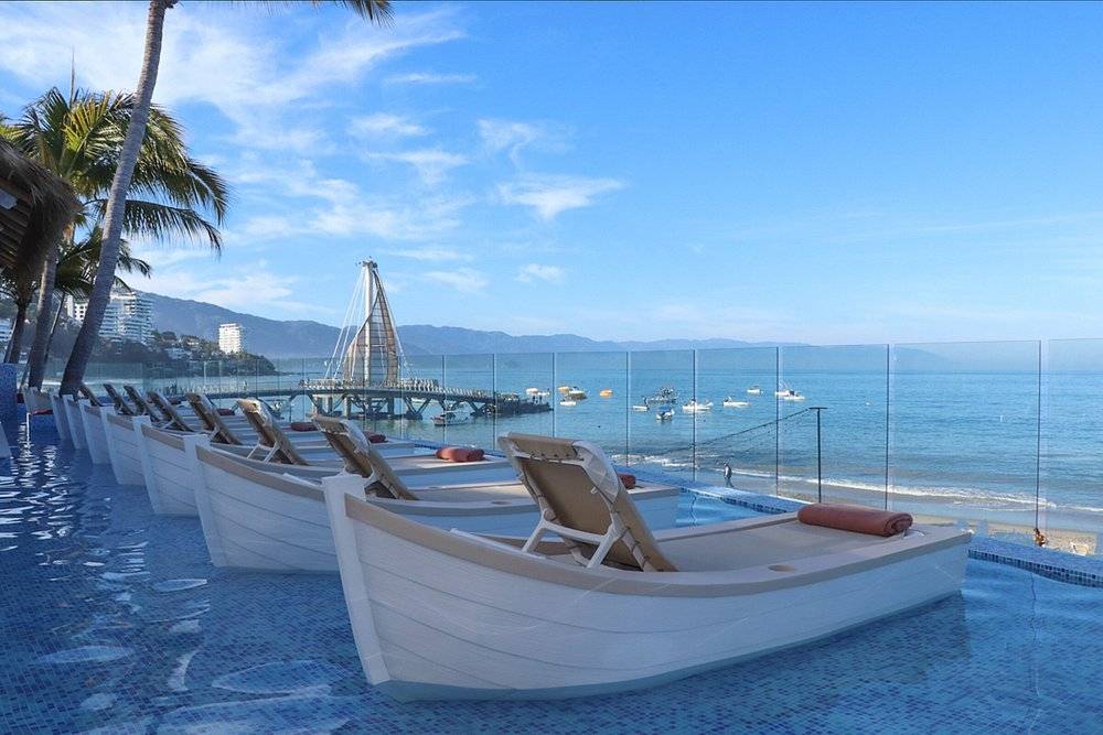 lounge chairs shaped like boats along beach