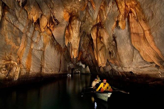 people canoeing in cave