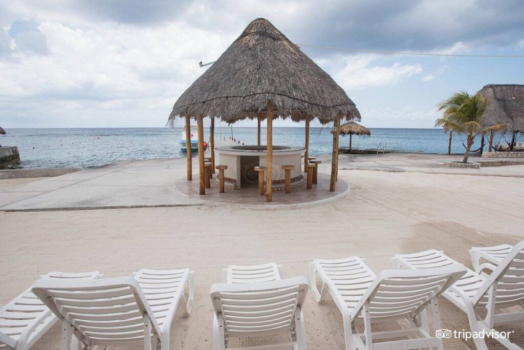 white lounge chairs on the beach