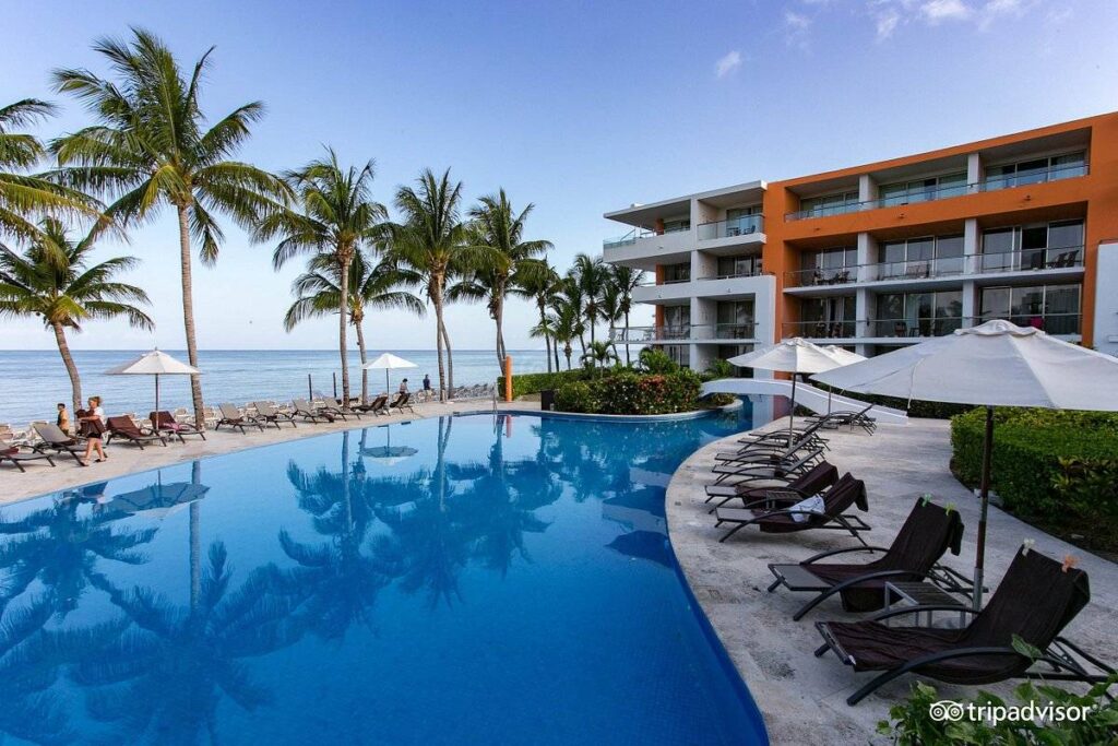 resort with pool and palm trees