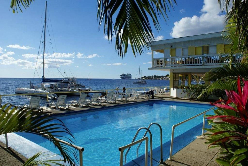 pool next to ocean with boat in background