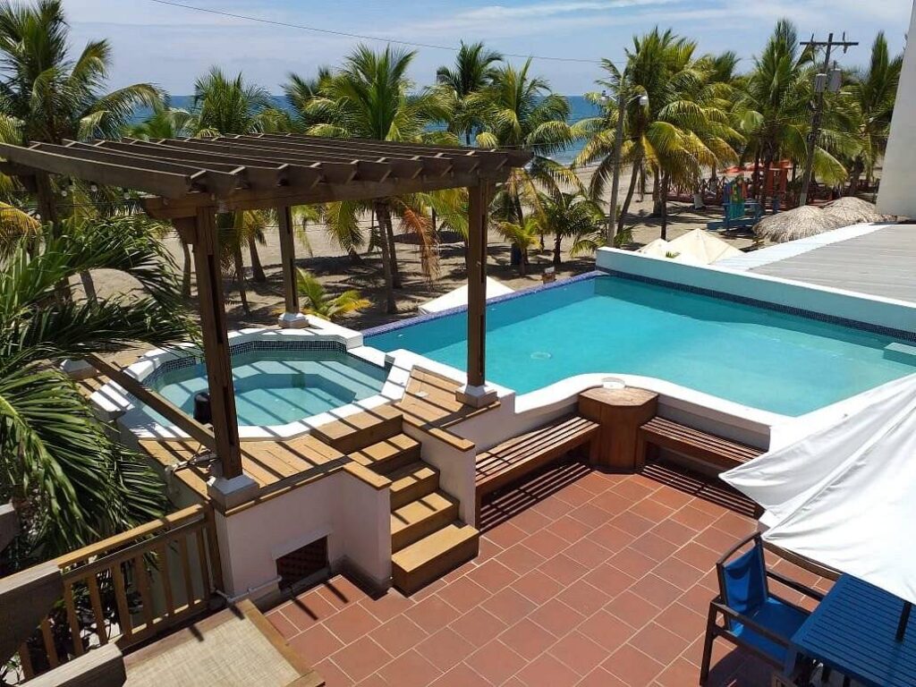 resort pool with jacuzzi under portico 