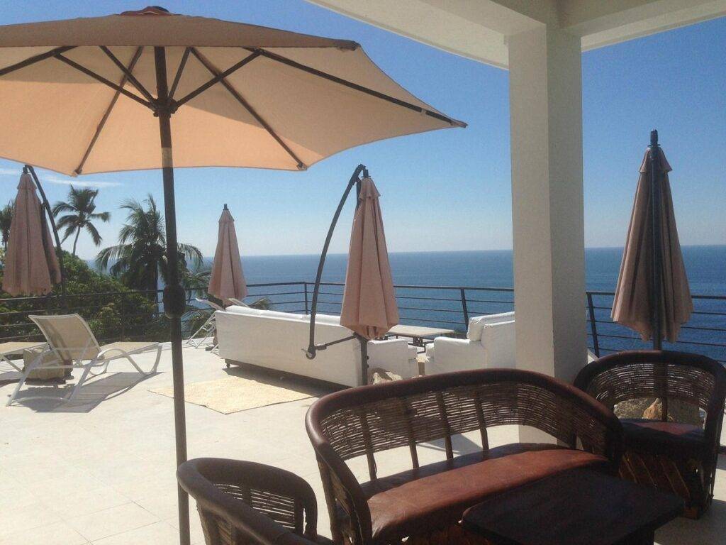 lounge chairs and umbrella on patio