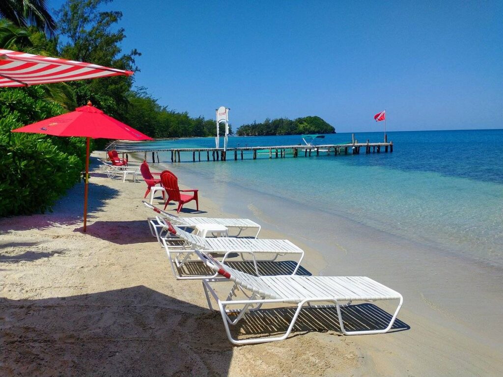 white lounge chairs on the beach