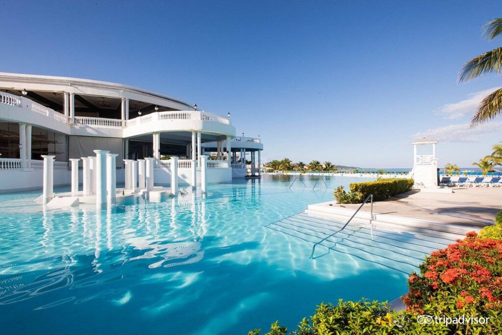 resort pool with white building