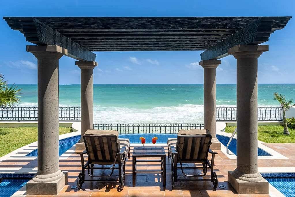 two chairs under pergola with private pool at the beach