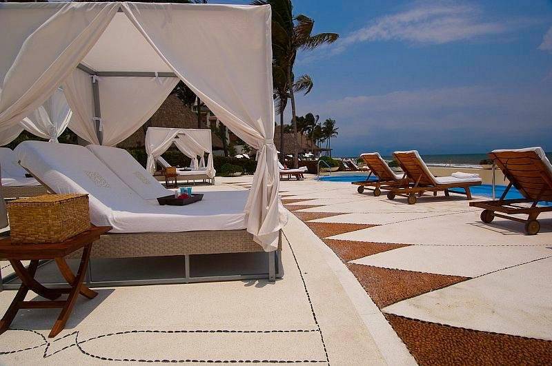 covered lounge chairs on cement patio