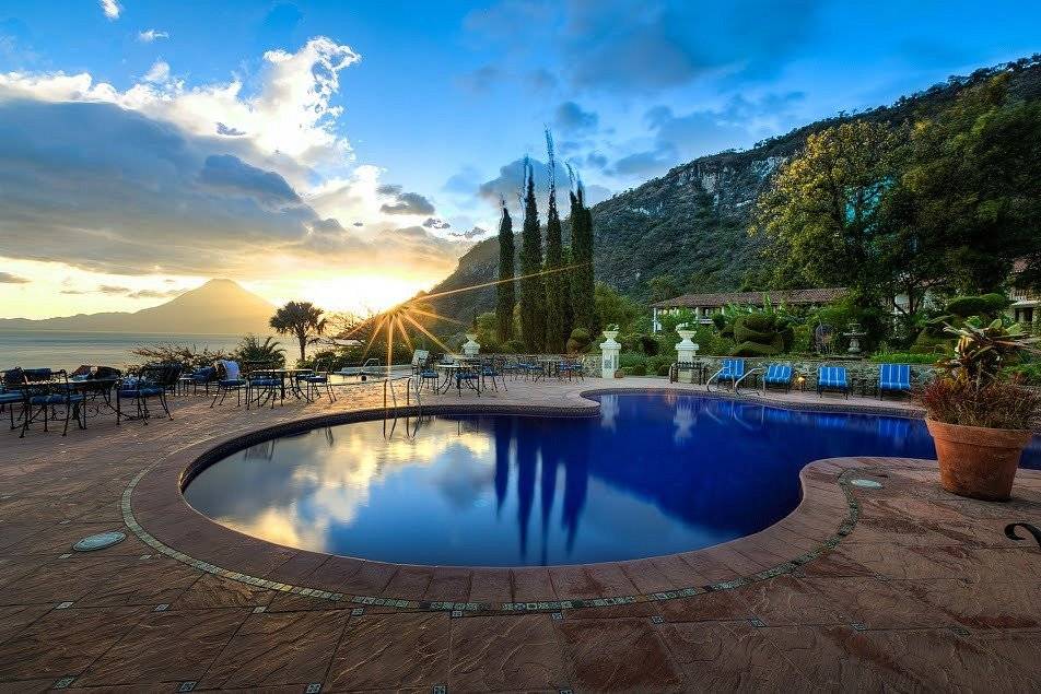 pool with mountain in background at sunset
