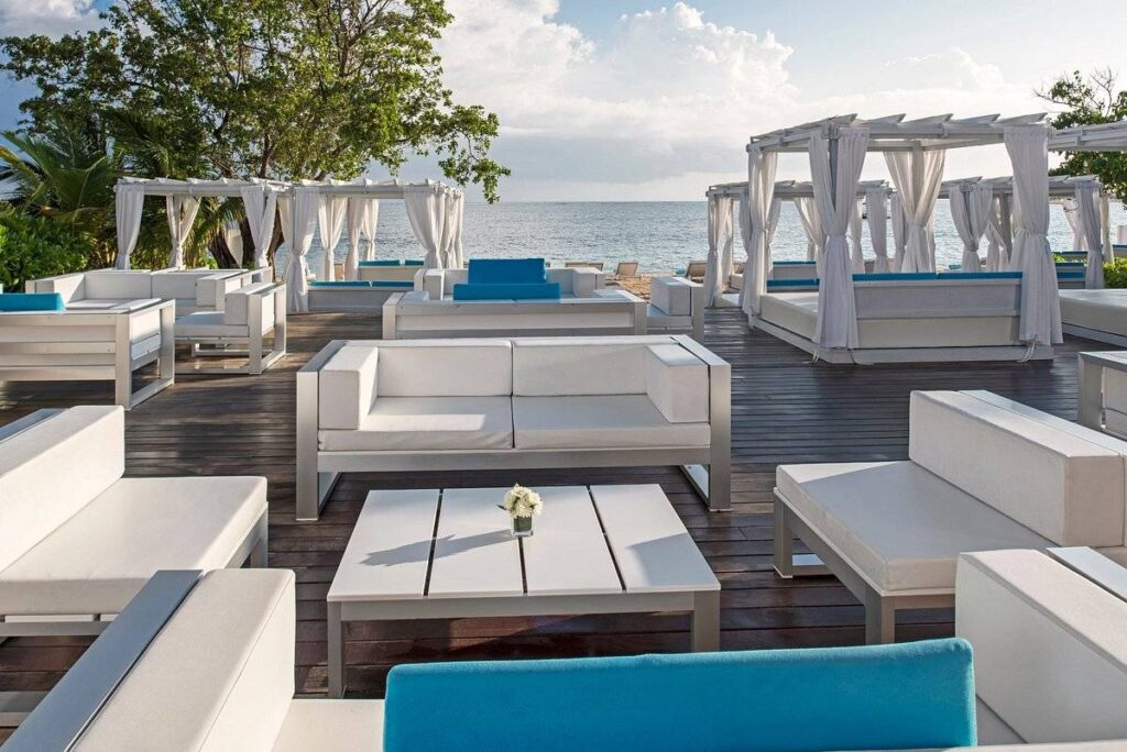 multiple white lounge furniture on wooden deck