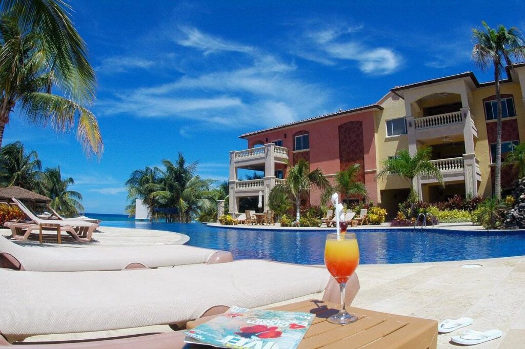 orange drink on table by resort pool