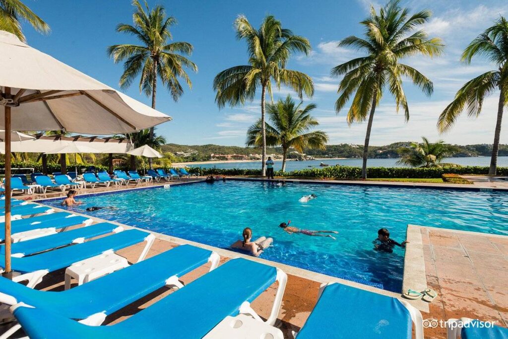 blue lounge chairs along square resort pool