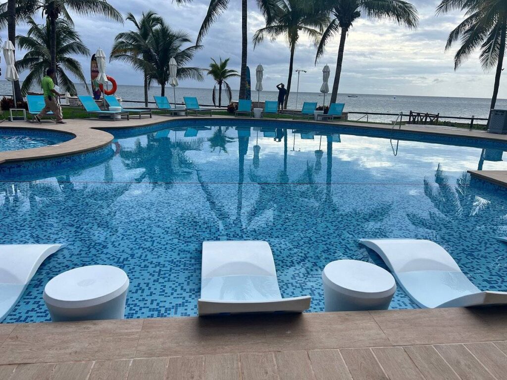 concrete lounge chairs in resort pool