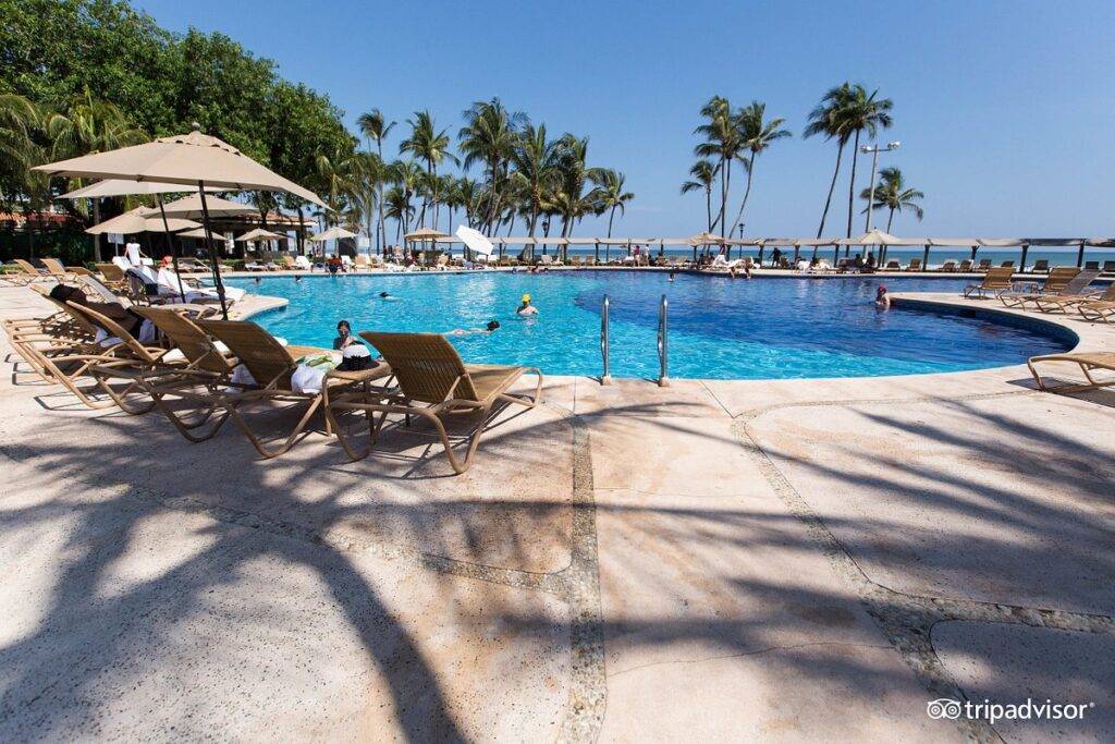 lounge chairs and umbrellas around circular pool