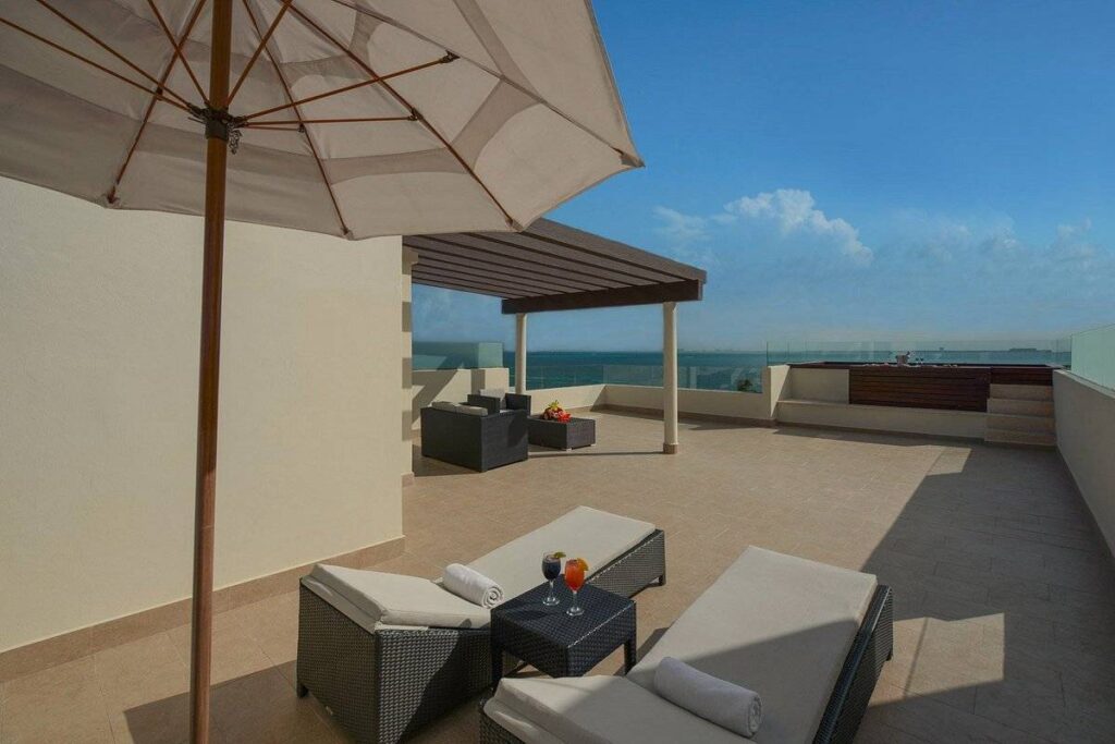 lounge chairs with umbrella on patio