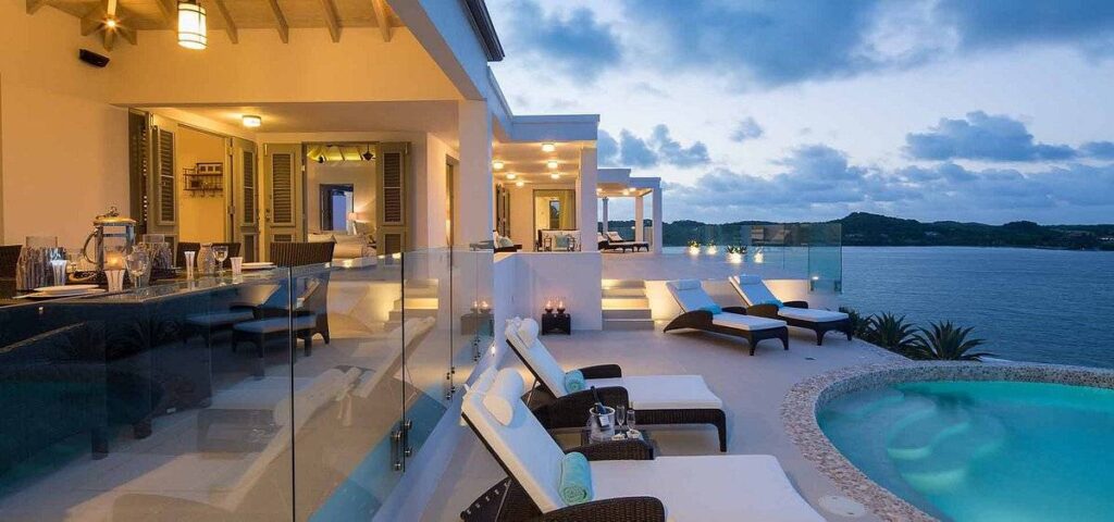 lounge chairs around pool at ocean