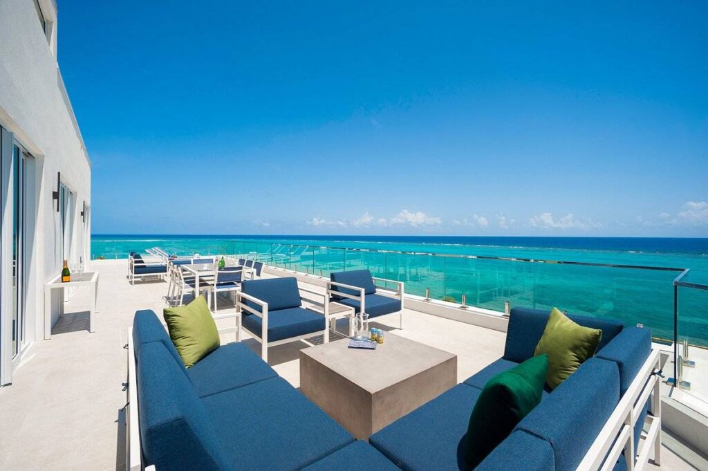 blue patio furniture next to ocean