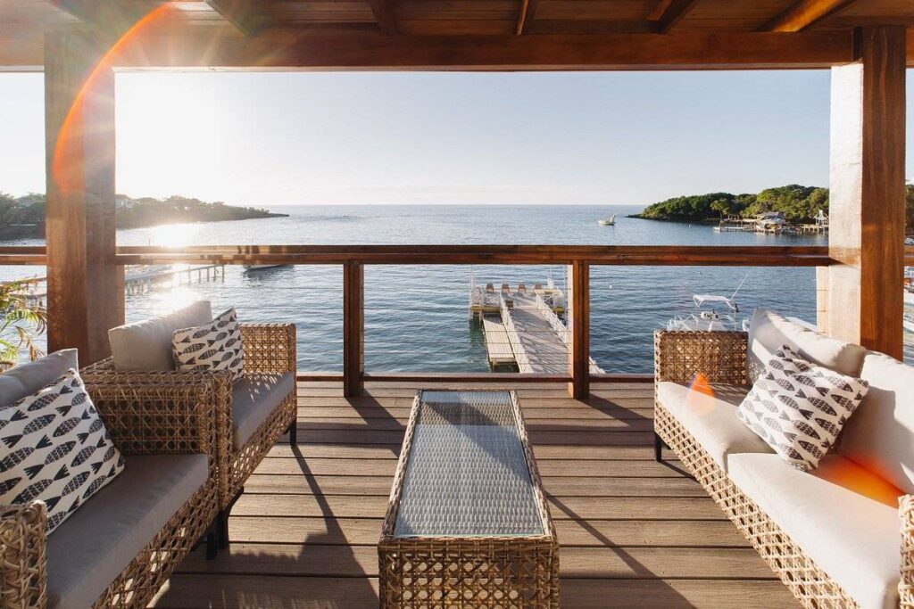wooden deck with deck furniture at water