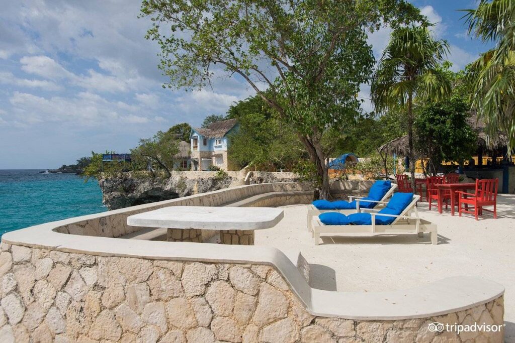 two blue lounge chairs on rock patio