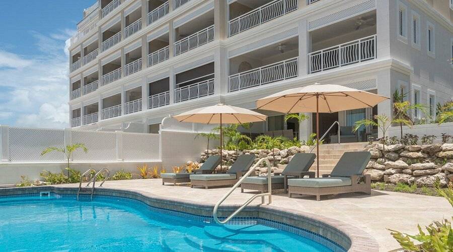 lounge chairs around pool at resort