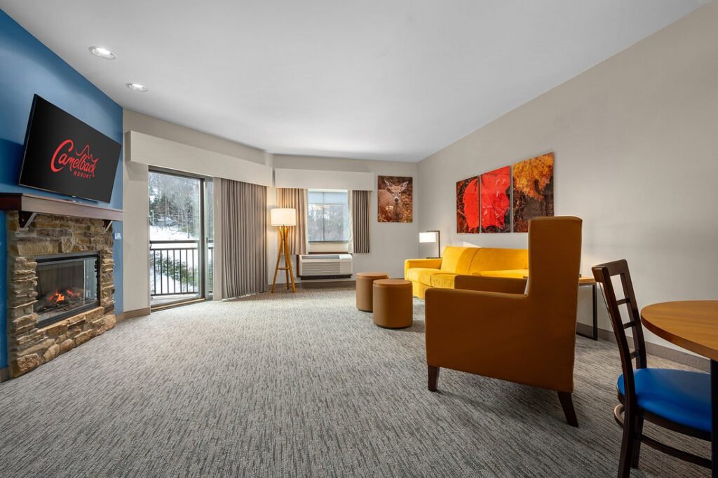 large open resort room with orange chairs 
