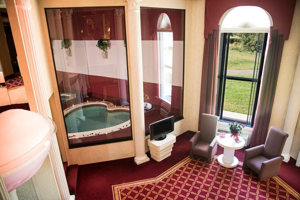 resort room with heart shaped tub with red carpet