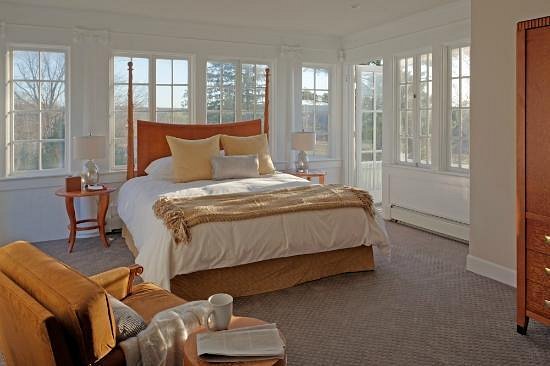 large bed with windows along every wall