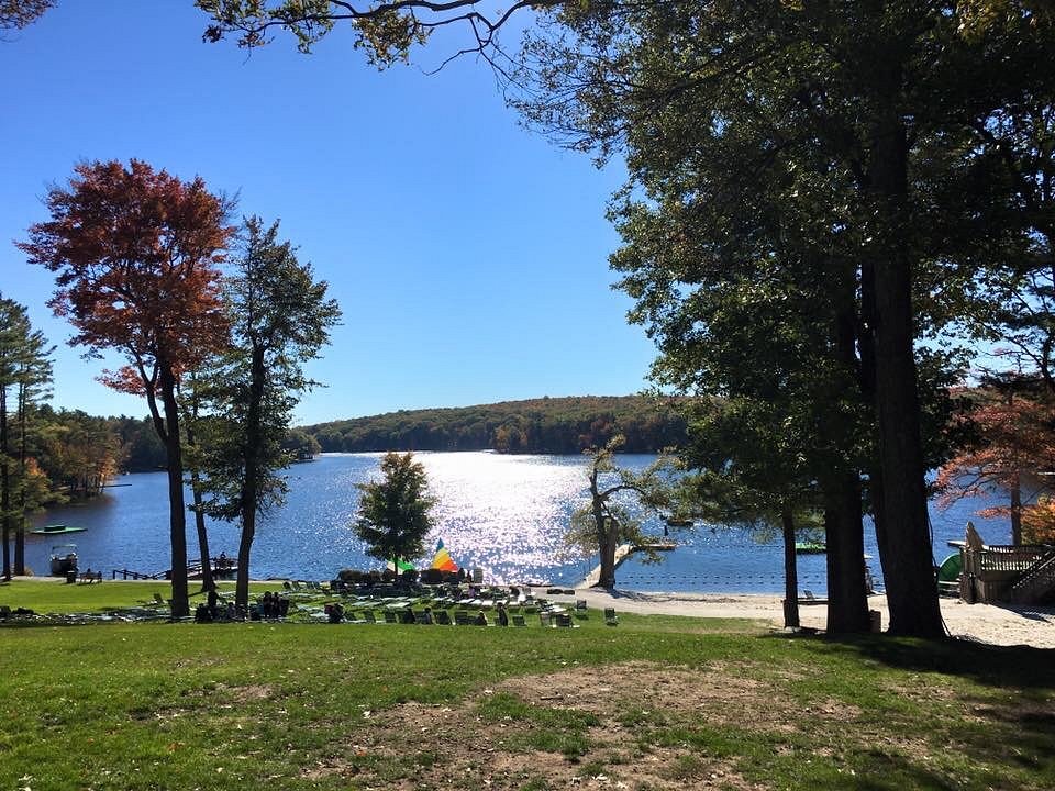 bench on a hill leading down to lake