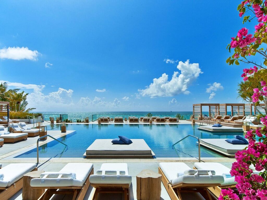 1 Hotel South Beach swimming pool lined with lounge chairs