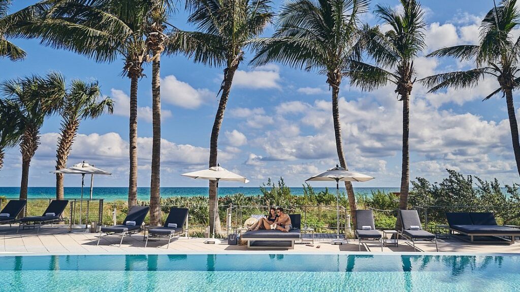 Carillon Miami Wellness Resort with palm trees lining swimming pool