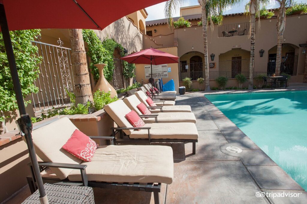 lounge chairs lining private resort pool