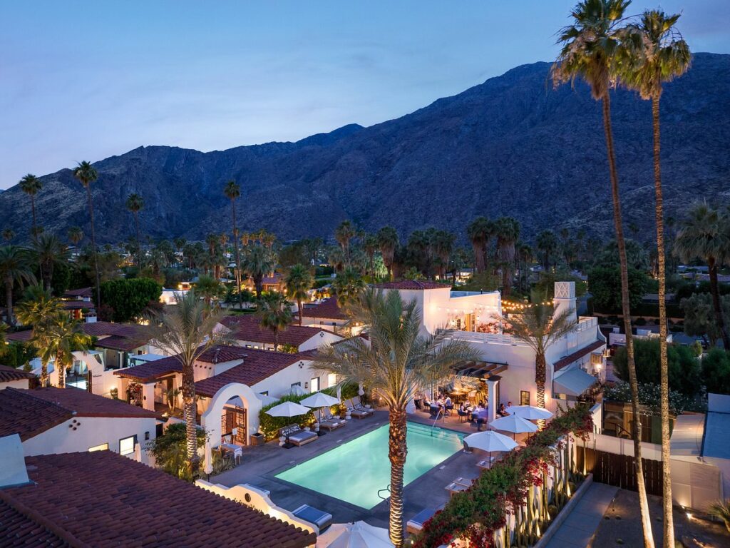 ariel view of resort pool area at dusk with mountains in the background