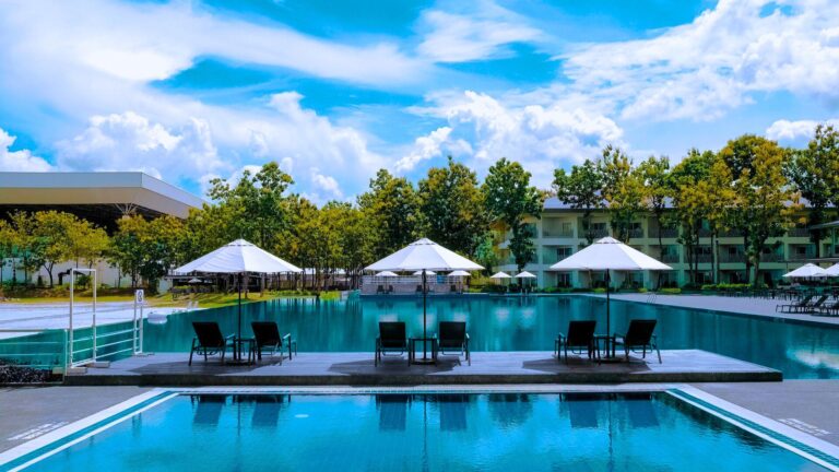 resort pool with umbrellas and lawn chairs