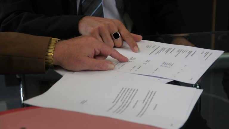 two men signing a contract
